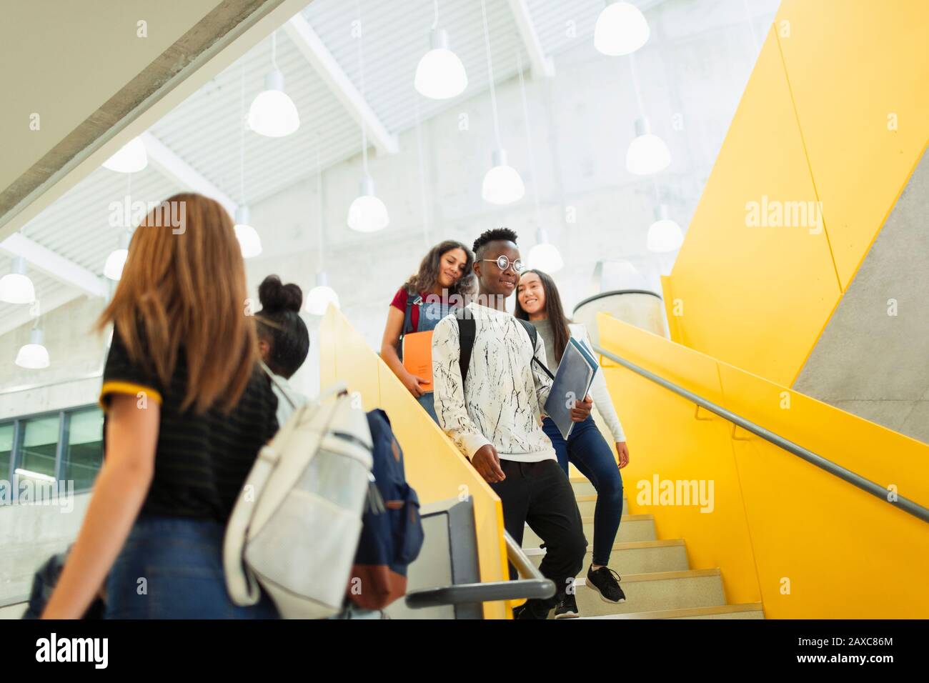 Junior high students descending stairs Stock Photo