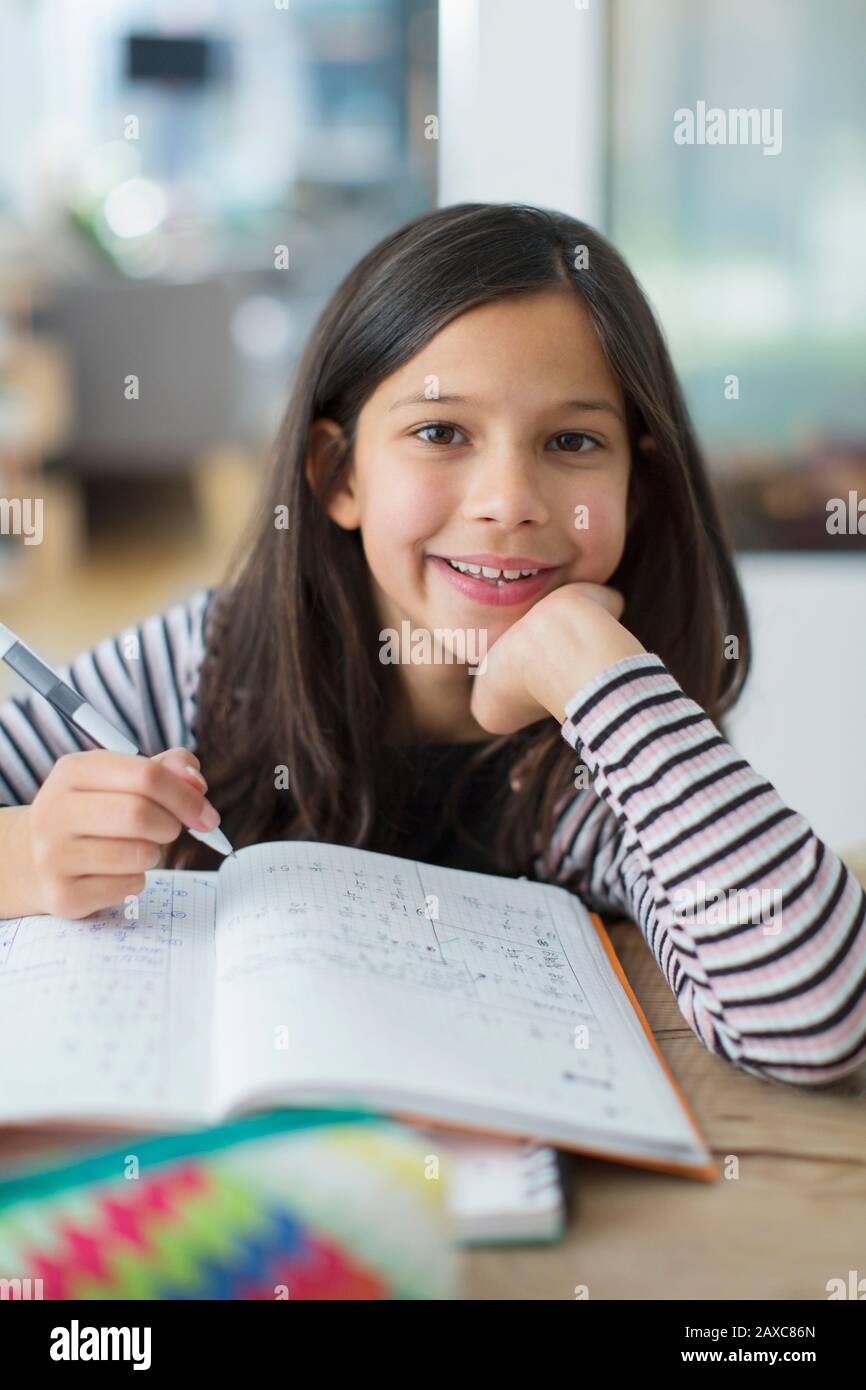 Portrait confident, smiling girl doing homework Stock Photo