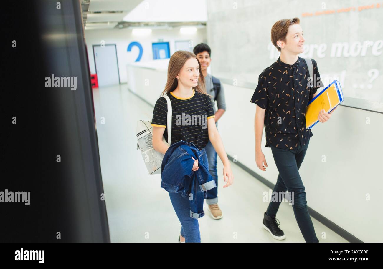 Junior high students walking in corridor Stock Photo