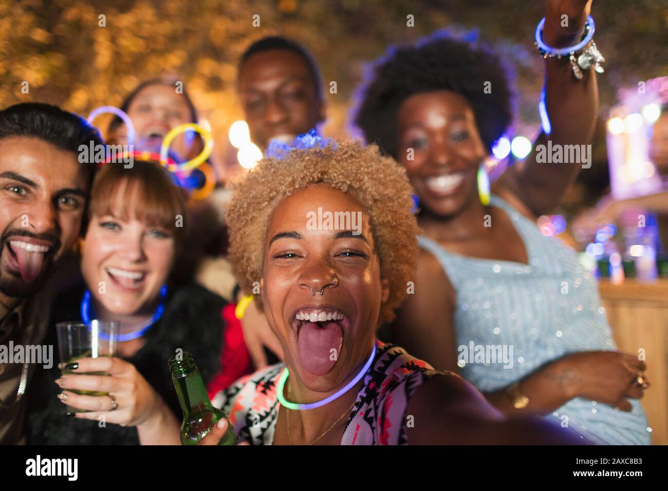 Portrait happy, exuberant friends cheering at garden party Stock Photo