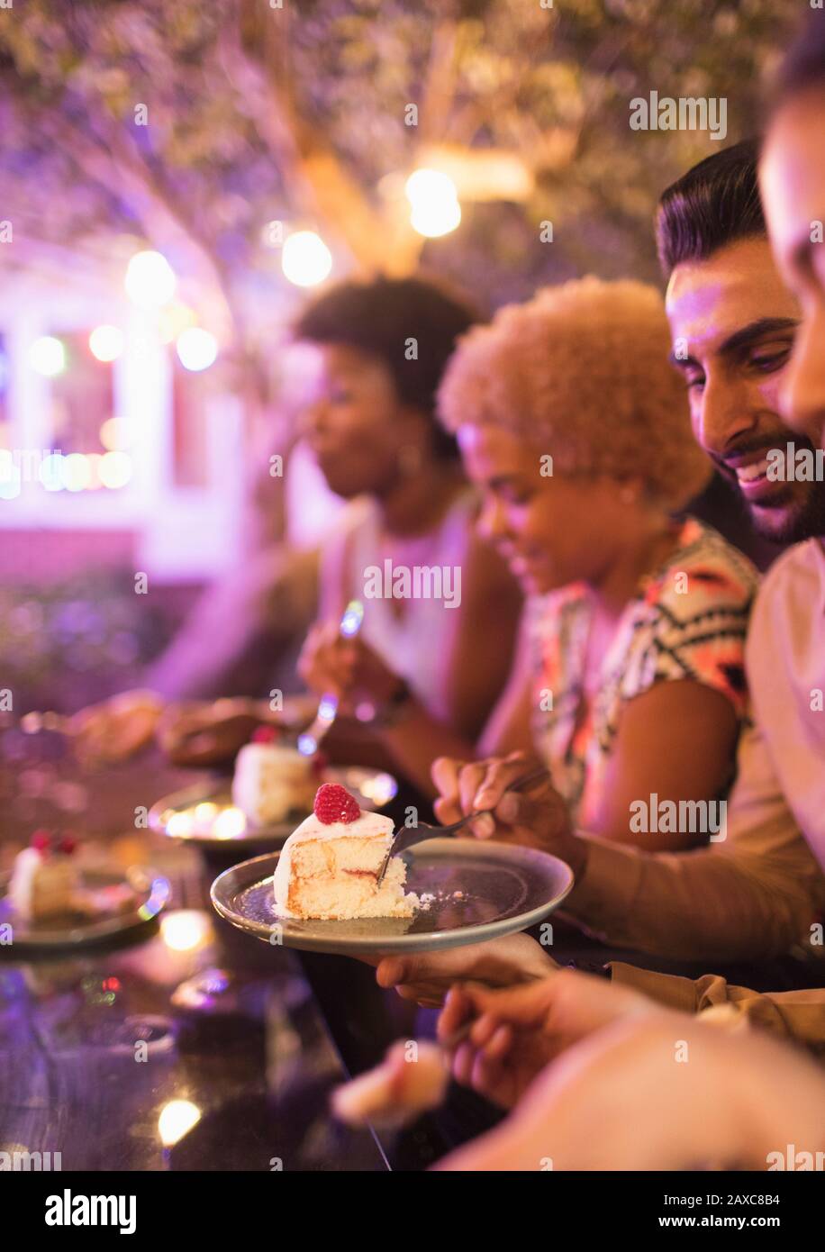 Friends eating dessert at garden party Stock Photo