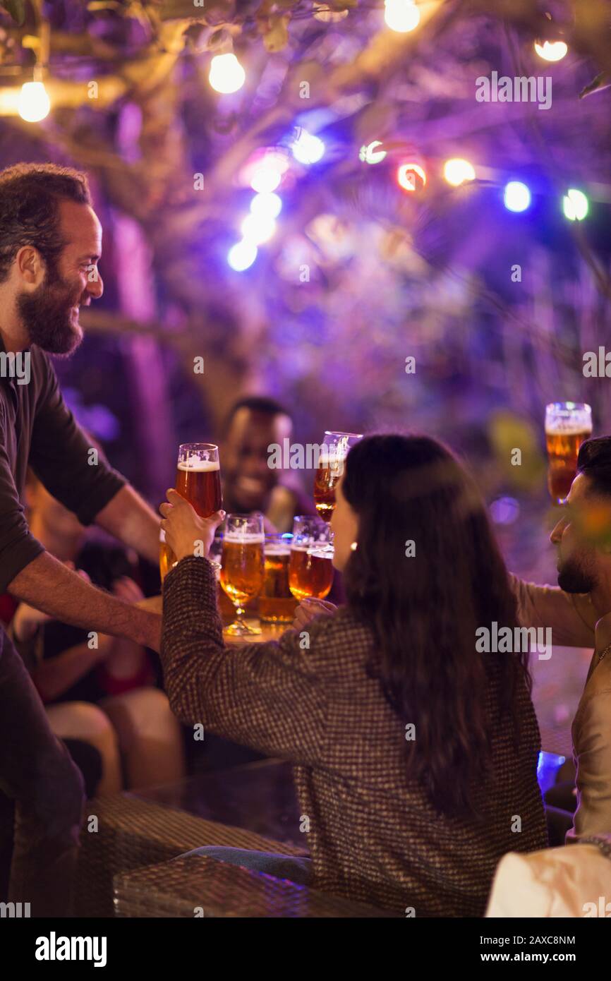 Friends drinking beer at garden party Stock Photo