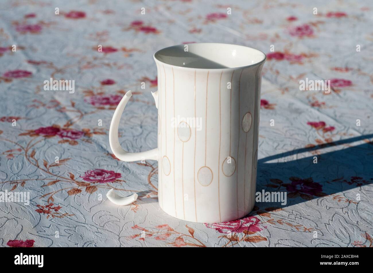 White porcelain milk mug with broken handle closeup on covered table Stock Photo Alamy