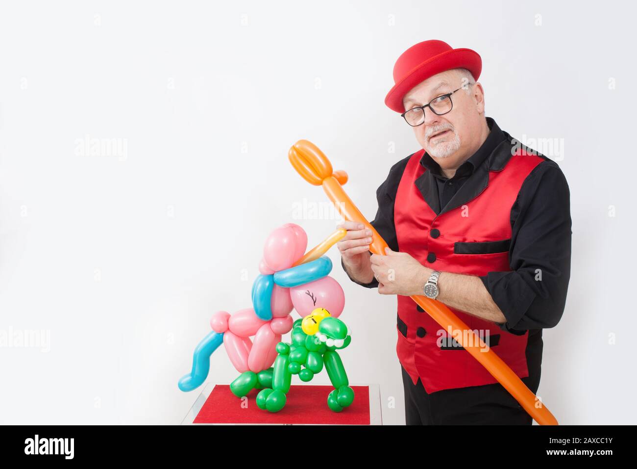 A children's entertainer doing tricks with balloons Stock Photo
