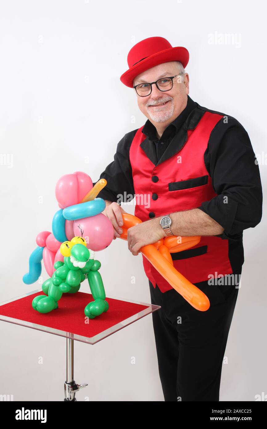A children's entertainer doing tricks with balloons Stock Photo