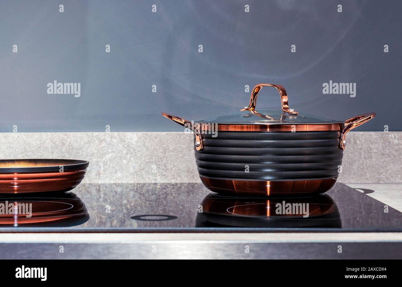 Copper pan on an induction stove. Utensils in the interior of the