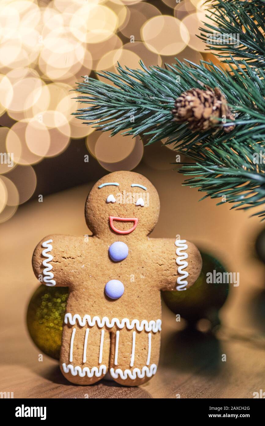 Gingerbread man on a Christmas background. Background with cookie and New Year decorations. Stock Photo