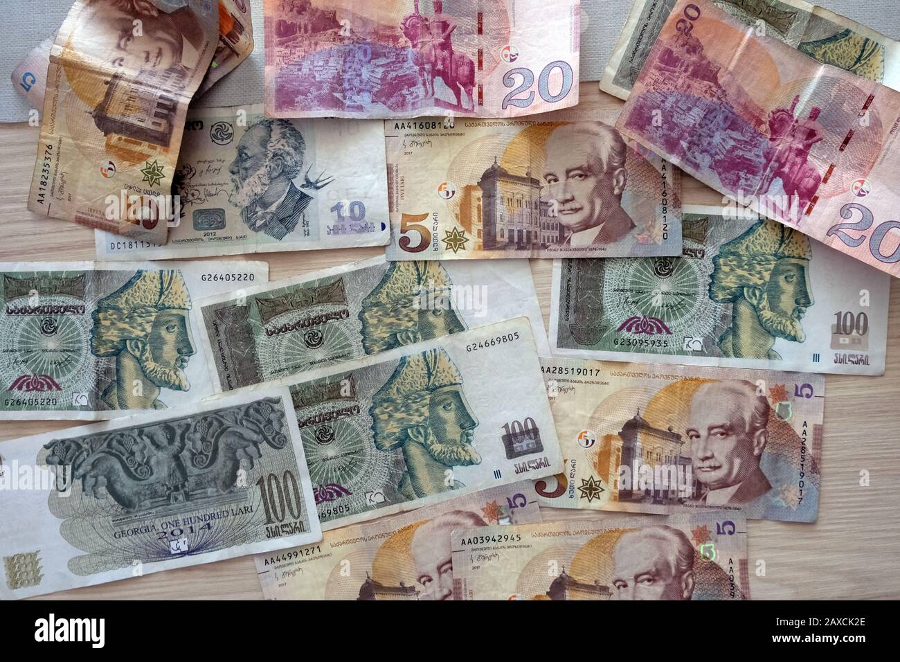 Georgian bills of different denominations on the table top view. Georgia paper money in 2020. Banknotes in denominations of 100, 10, 5 and 20 on a woo Stock Photo