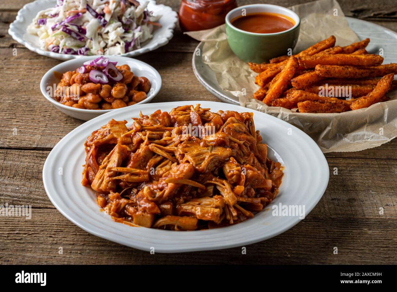 Vegan BBQ plate. Jackfruit barbecued, Southern style baked beans, coleslaw, dinner rolls and