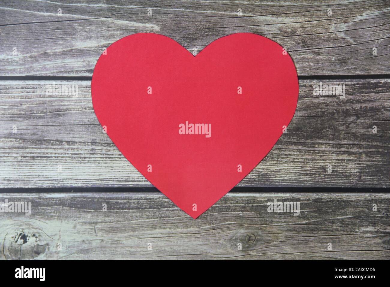 Red heart made of paper symbol of love on a background of wooden boards ...