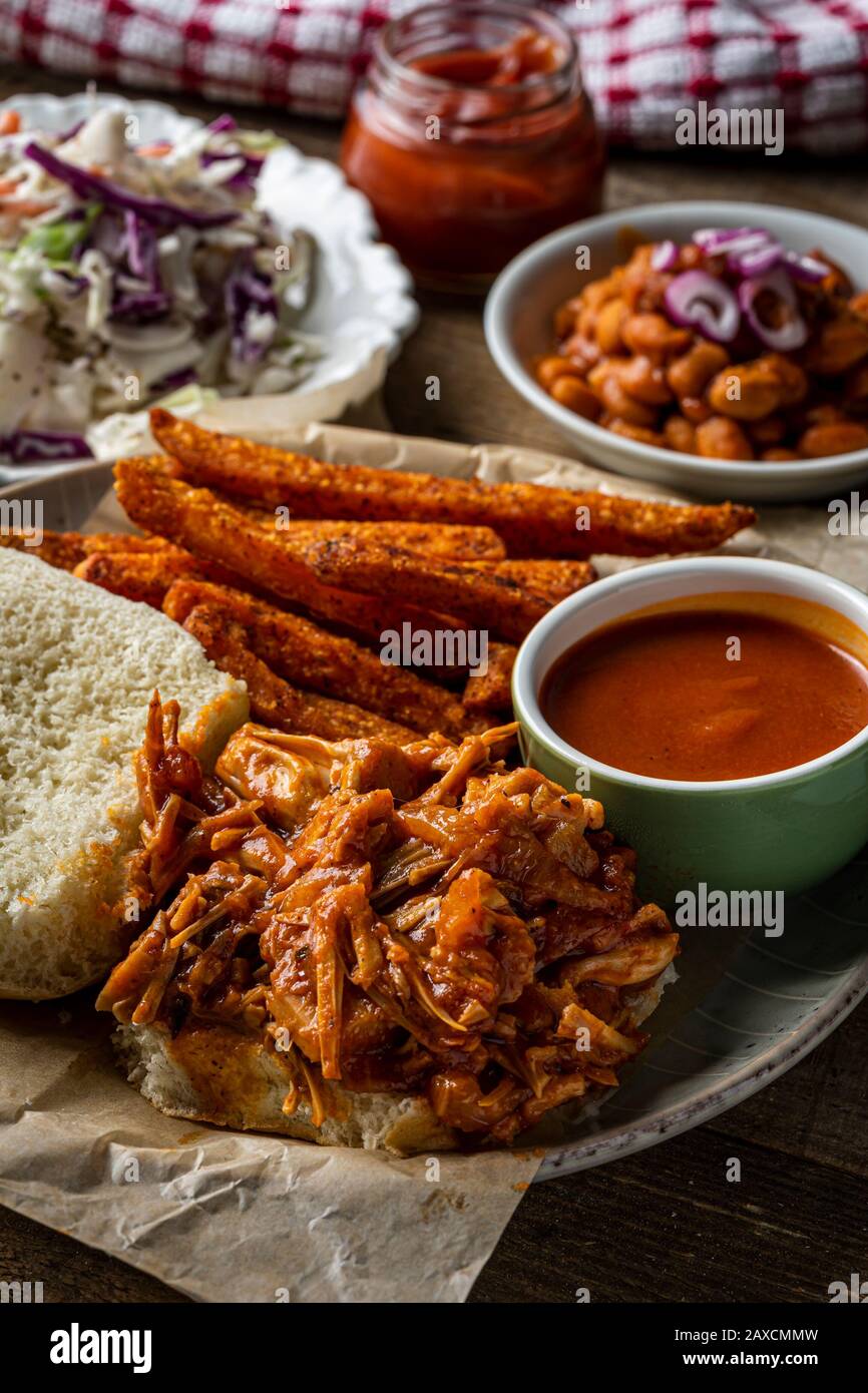 Vegan BBQ sandwich. Barbecue jackfruit with sweet potato fries