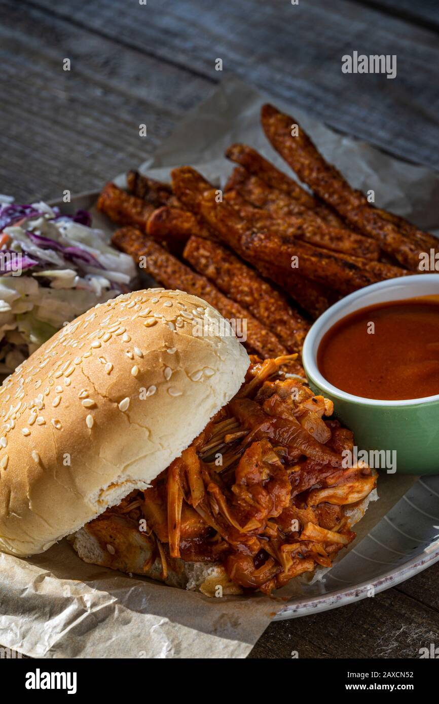Vegan BBQ sandwich. Barbecue jackfruit with sweet potato fries
