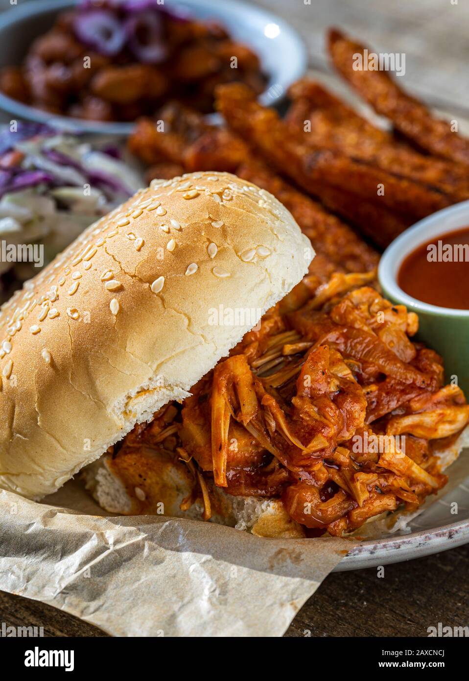 Vegan BBQ sandwich. Barbecue jackfruit with sweet potato fries