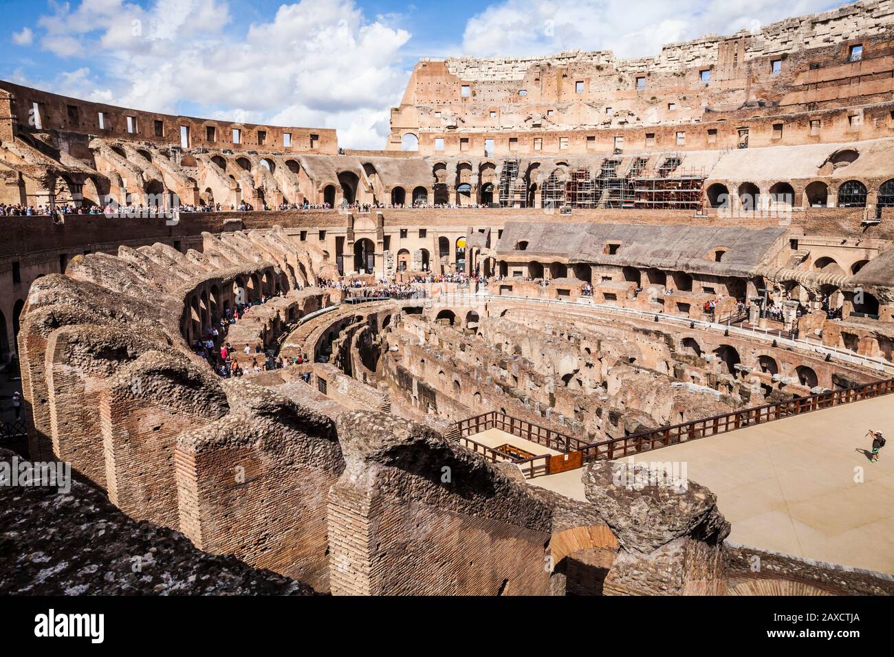 A wide angle view of the interior of the Colosseum in Rome, Italy with tourists wandering about. Stock Photo