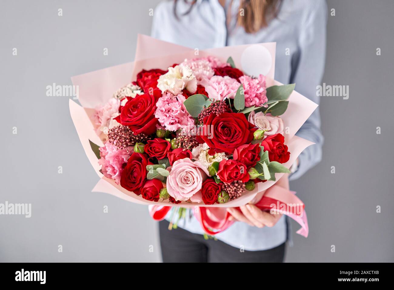 European floral shop. Beautiful bouquet of mixed flowers in womans