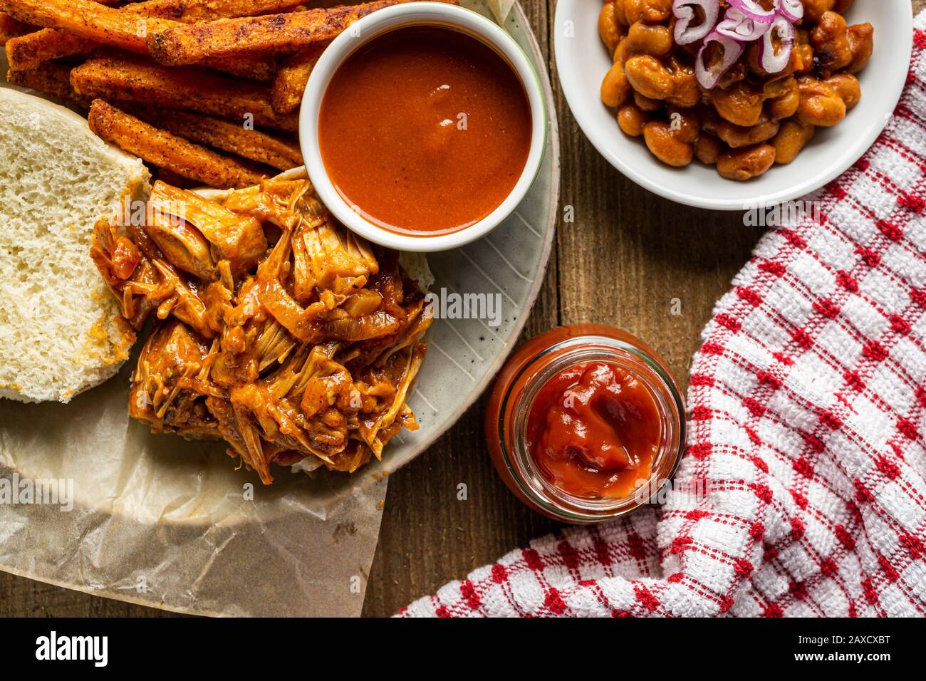 Vegan BBQ sandwich. Barbecue jackfruit with sweet potato fries