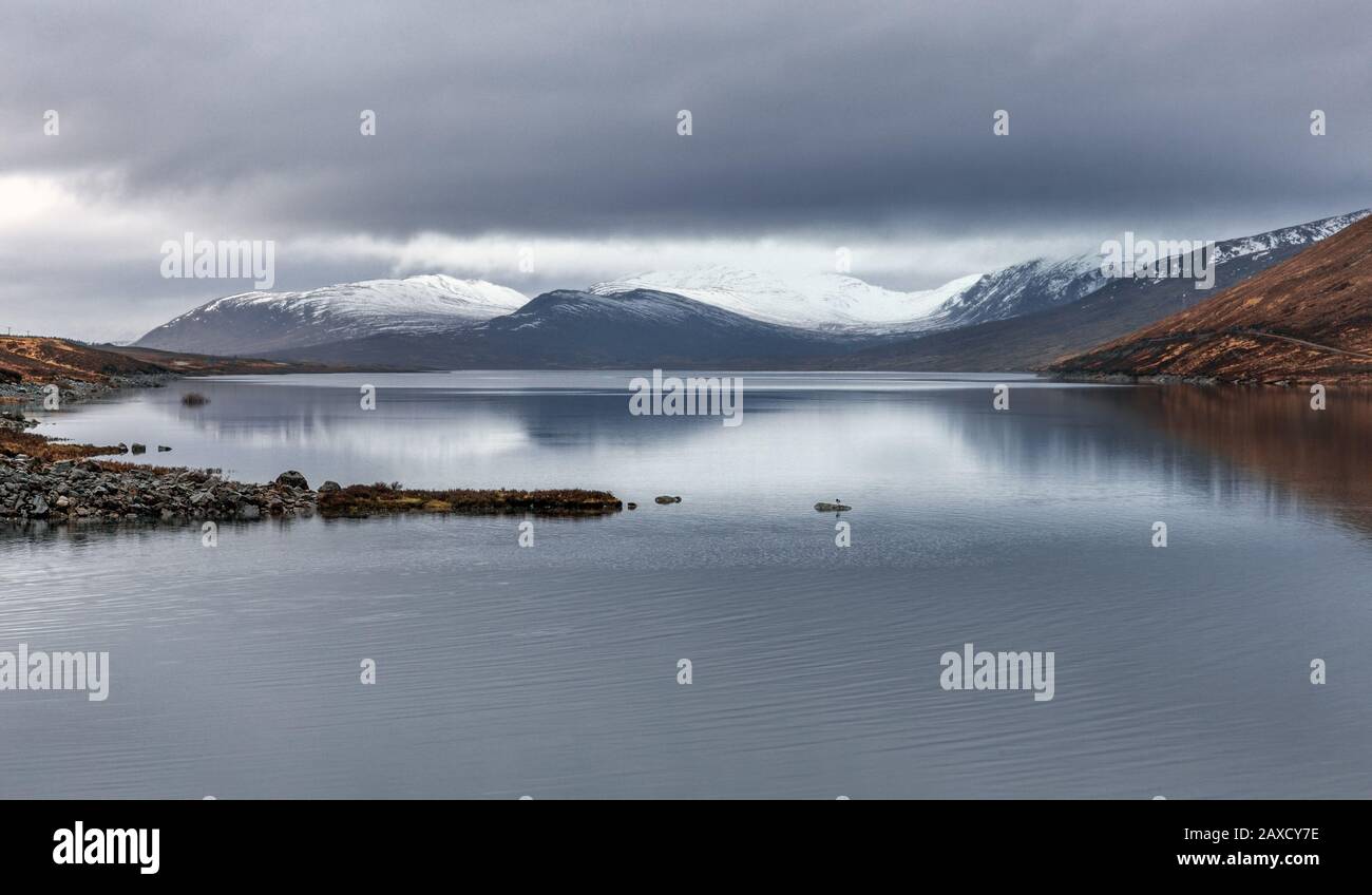 Loch Glascarnoch, with snow topped mountains in the distance, Wester Ross in the North West Highlands of Scotland, United Kingdom, Europe Stock Photo