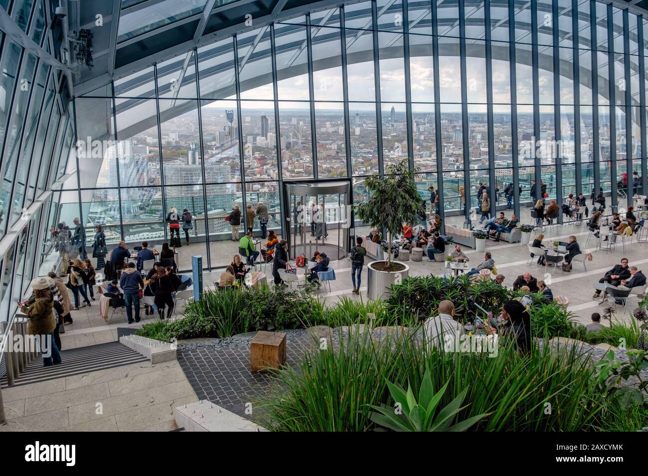Visitors enjoying the view from the Sky Garden top floor of the Walkie Talkie skyscraper building or 20 Fenchurch Street City of London England UK Stock Photo