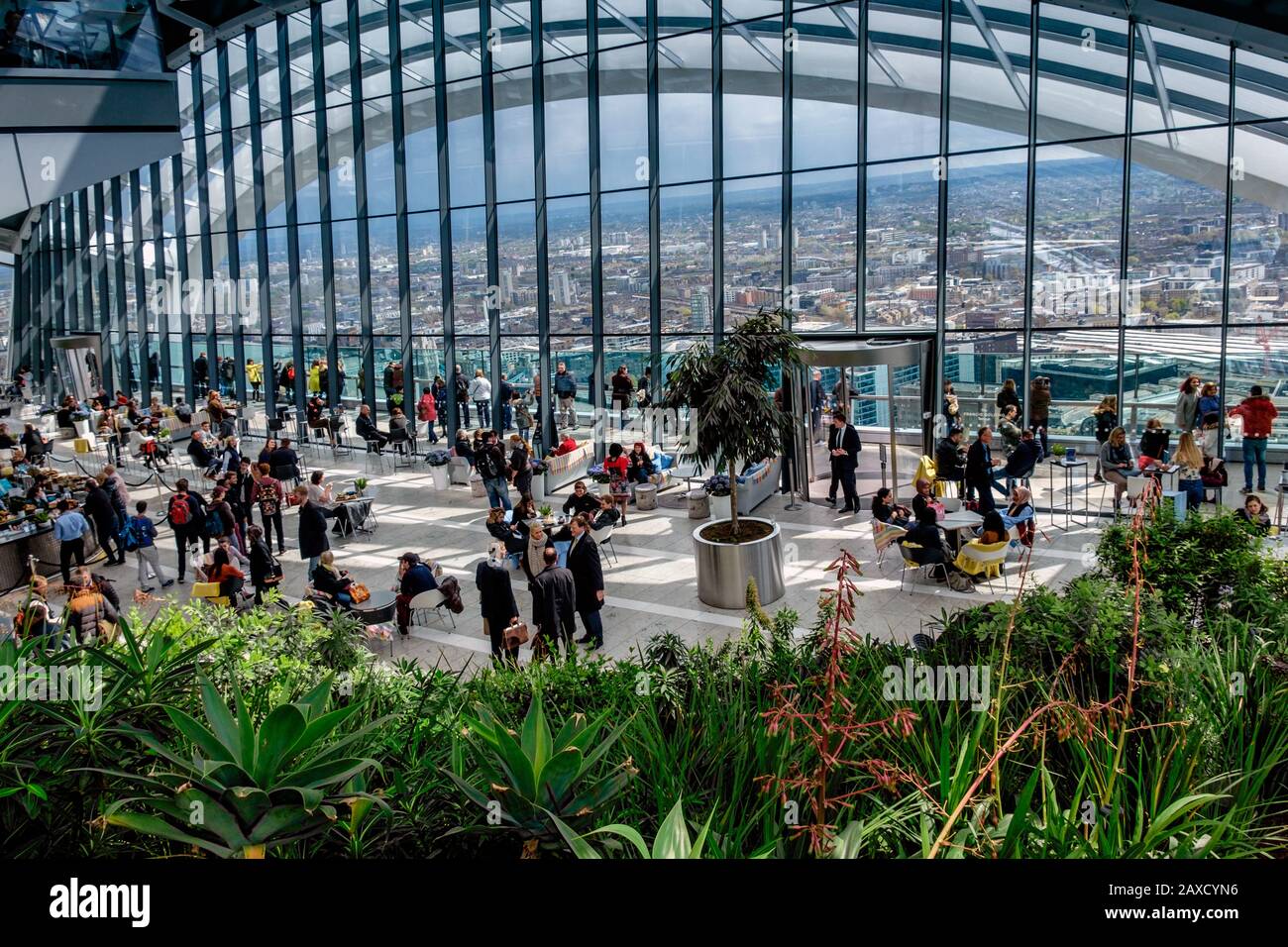 Visitors enjoying the view from the Sky Garden top floor of the Walkie Talkie skyscraper building or 20 Fenchurch Street City of London England UK Stock Photo