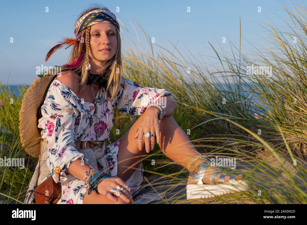 Beautiful woman wearing long dress and accessories boho style. Attractive  bohemian style girl on the beach Stock Photo - Alamy