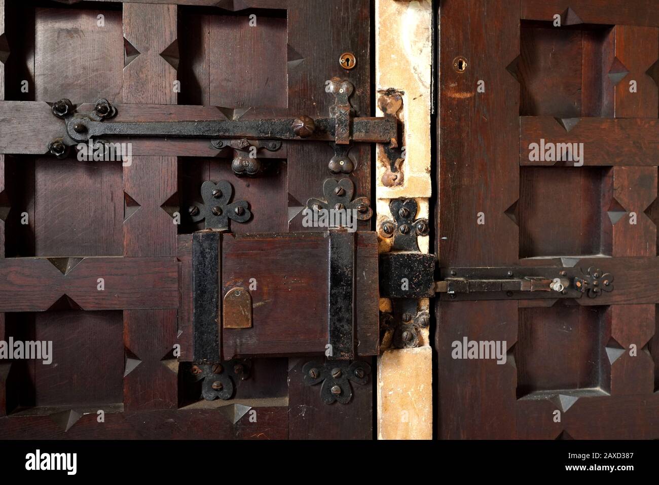 A closeup of a rustic lock and hinges on a church door in the UK Stock