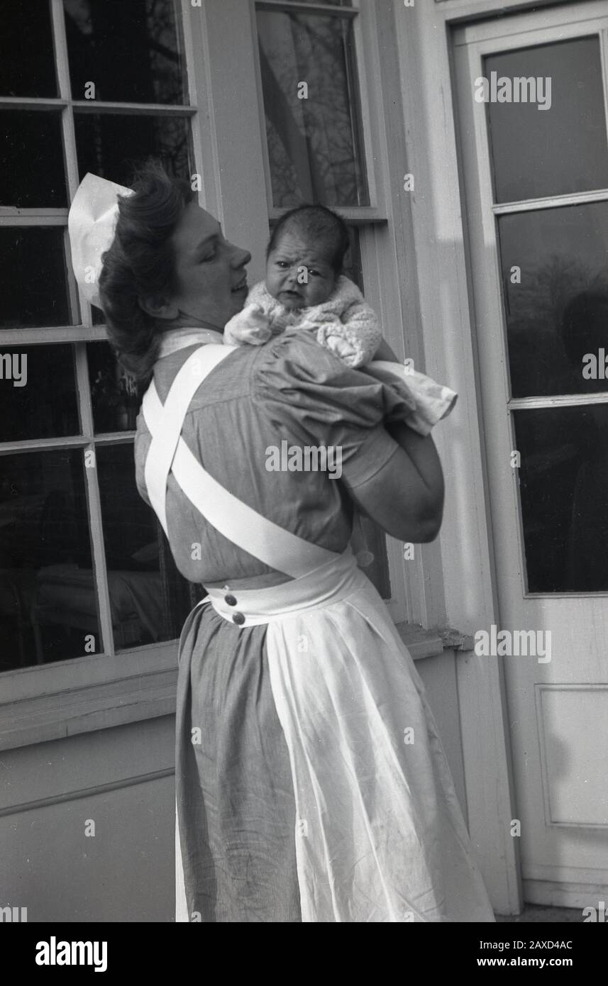 Nurse holding baby uk hi-res stock photography and images - Alamy