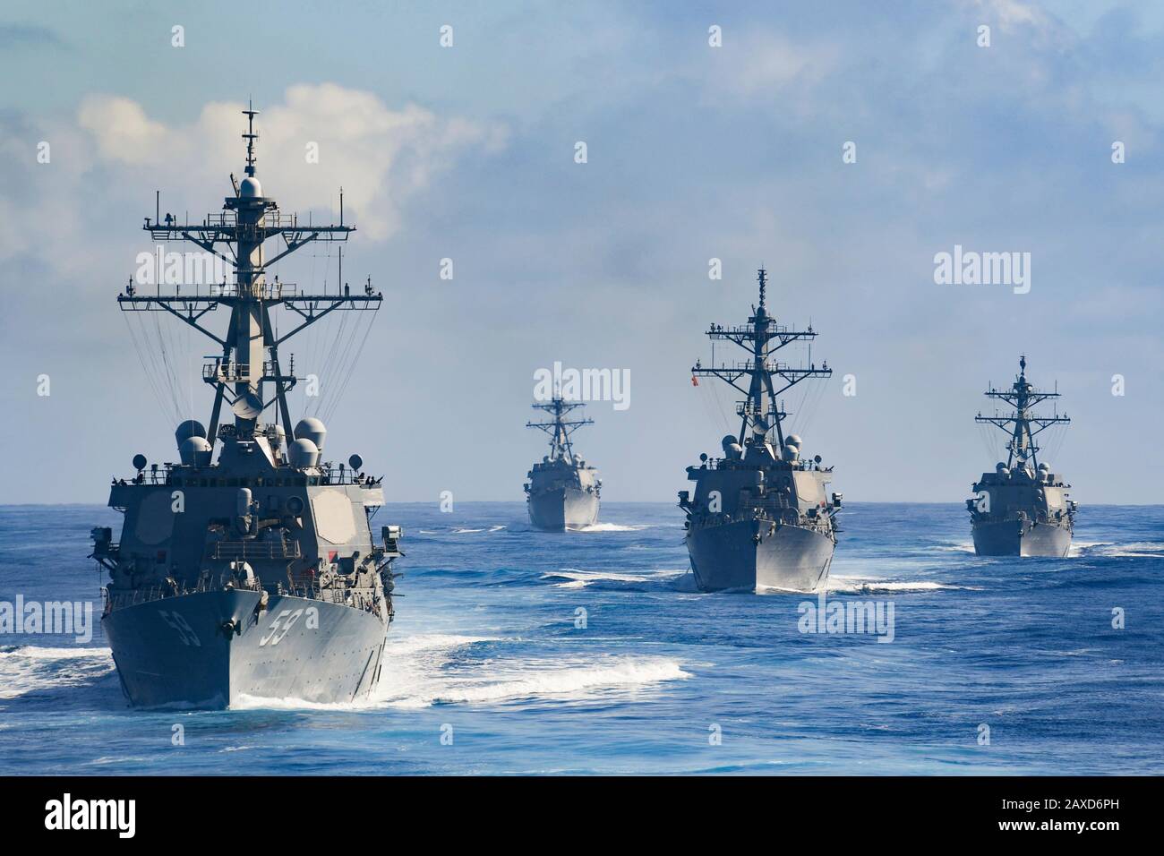 The U.S. Navy Theodore Roosevelt Carrier Strike Group Destroyer Squadron 23, led by the Arleigh Burke-Class guided-missile destroyer USS Russell transits the Pacific Ocean in formation January 24, 2020 in the Pacific Ocean. Stock Photo