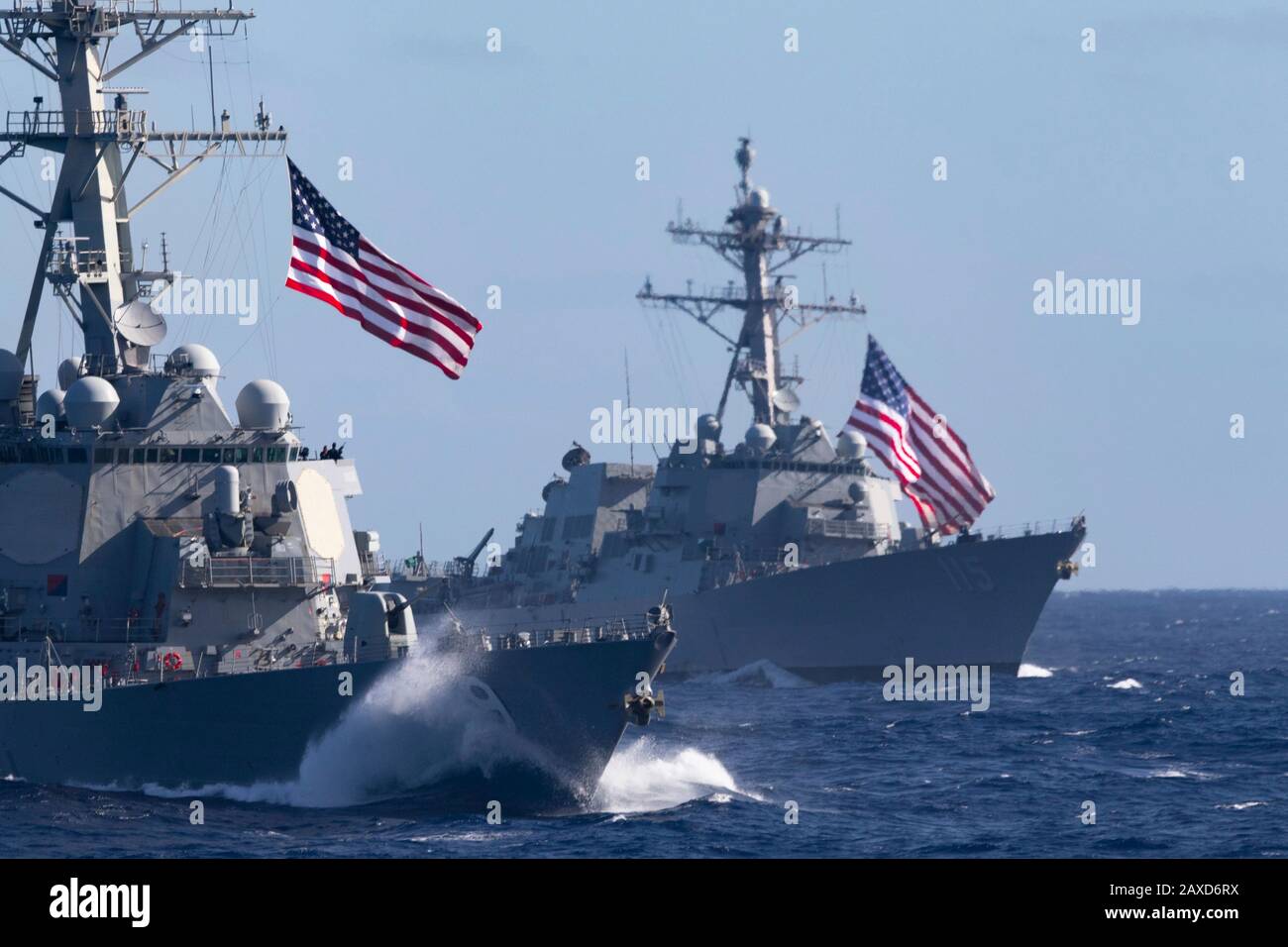 The U.S. Navy Arleigh Burke-class guided-missile destroyers USS Russell, left, and USS Rafael Peralta transition the Pacific Ocean with the Theodore Roosevelt Carrier Strike Group January 25, 2020 in the Pacific Ocean. Stock Photo