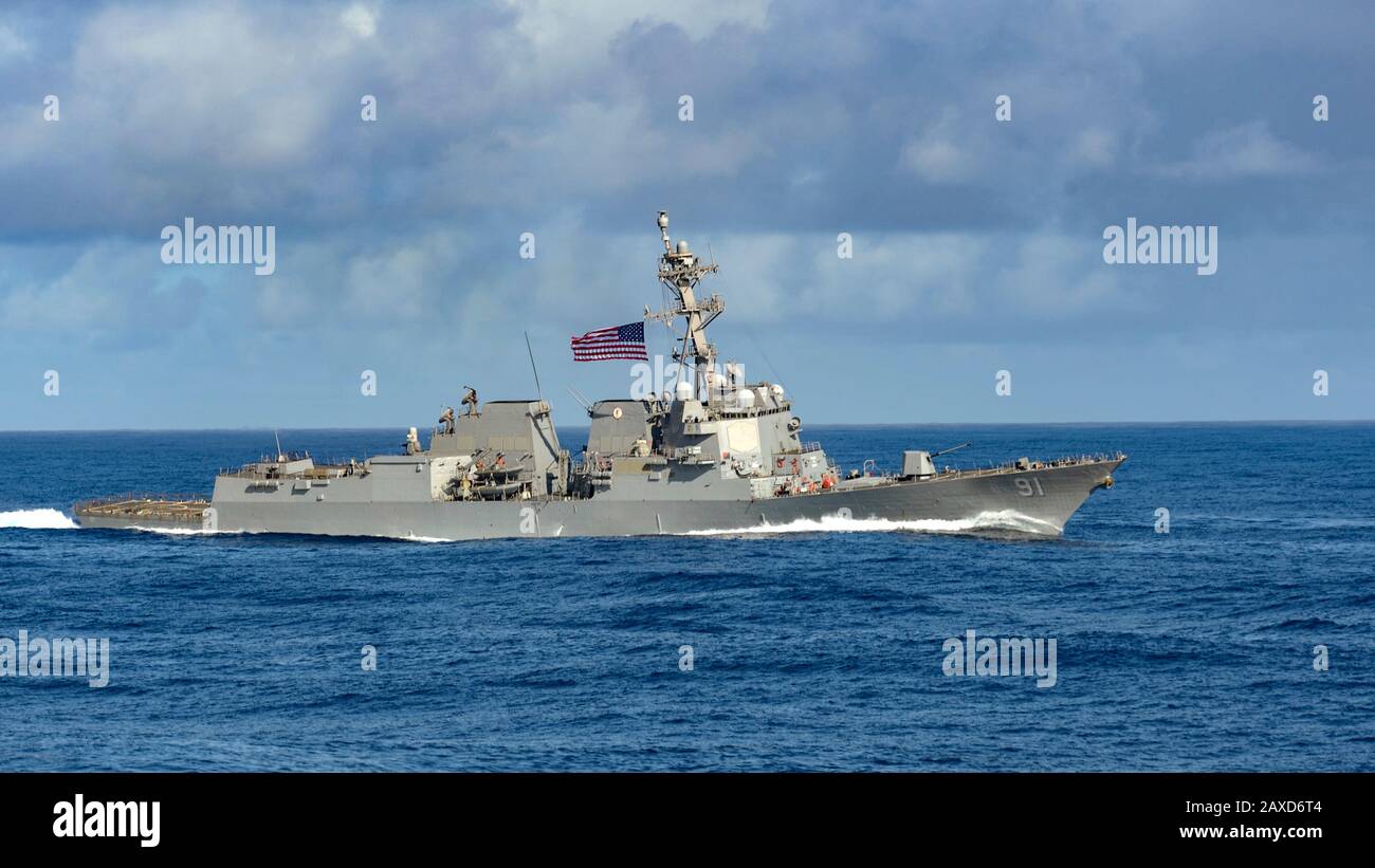 The U.S. Navy Arleigh Burke-class guided-missile destroyer USS Pinckney transitions the Pacific Ocean with the Theodore Roosevelt Carrier Strike Group February 3, 2020 in the Pacific Ocean. Stock Photo