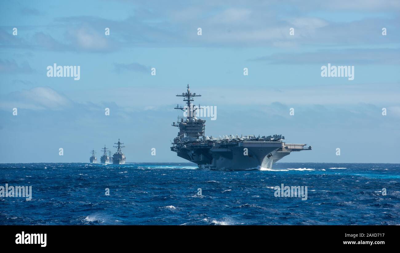 The U.S. Navy Nimitz-class nuclear powered aircraft carrier USS Theodore Roosevelt and the Destroyer Squadron 23 transit the Pacific Ocean in formation January 25, 2020 in the Pacific Ocean. Stock Photo