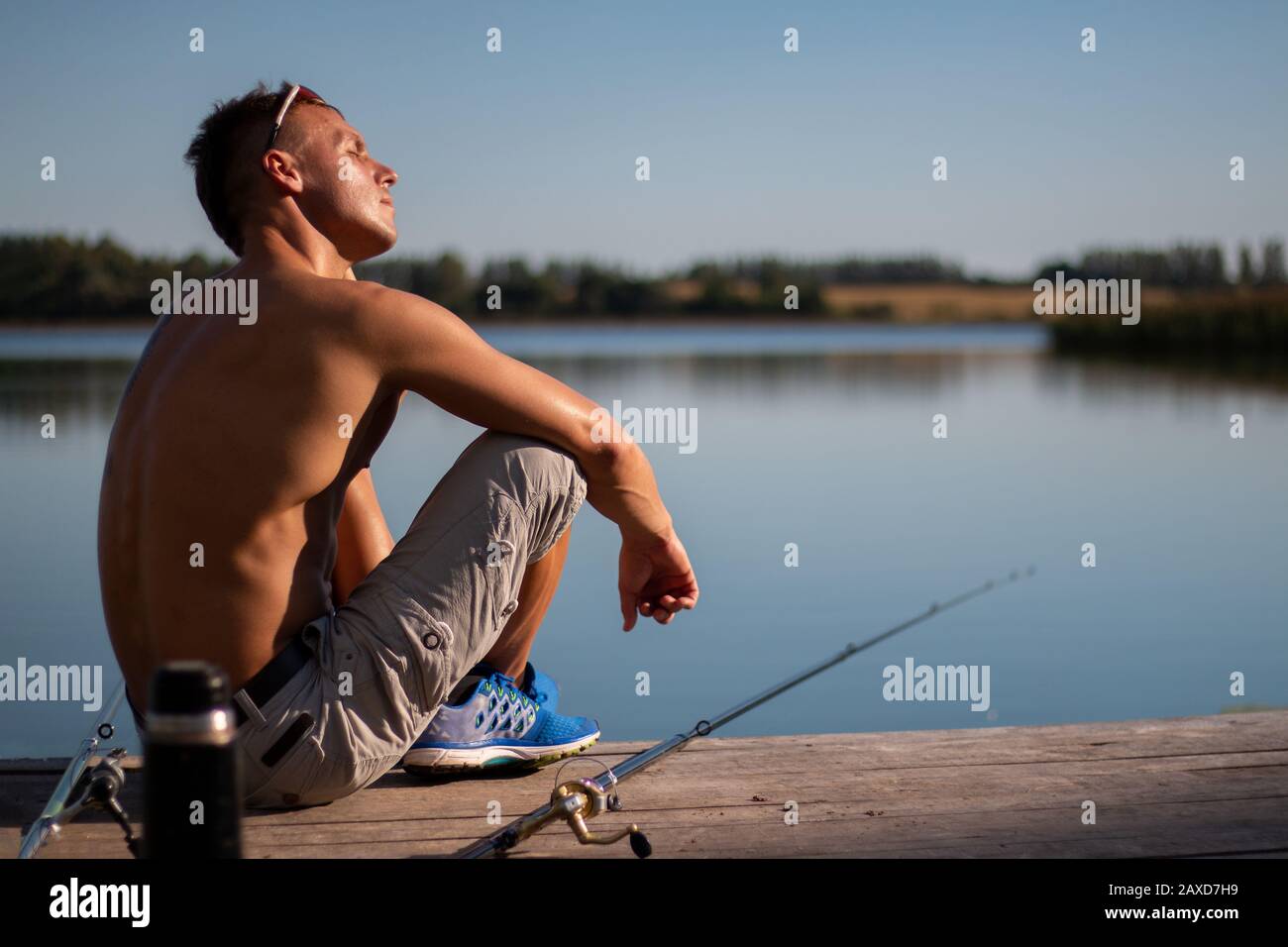https://c8.alamy.com/comp/2AXD7H9/a-beautiful-man-with-a-bare-cake-with-a-fishing-rod-2AXD7H9.jpg