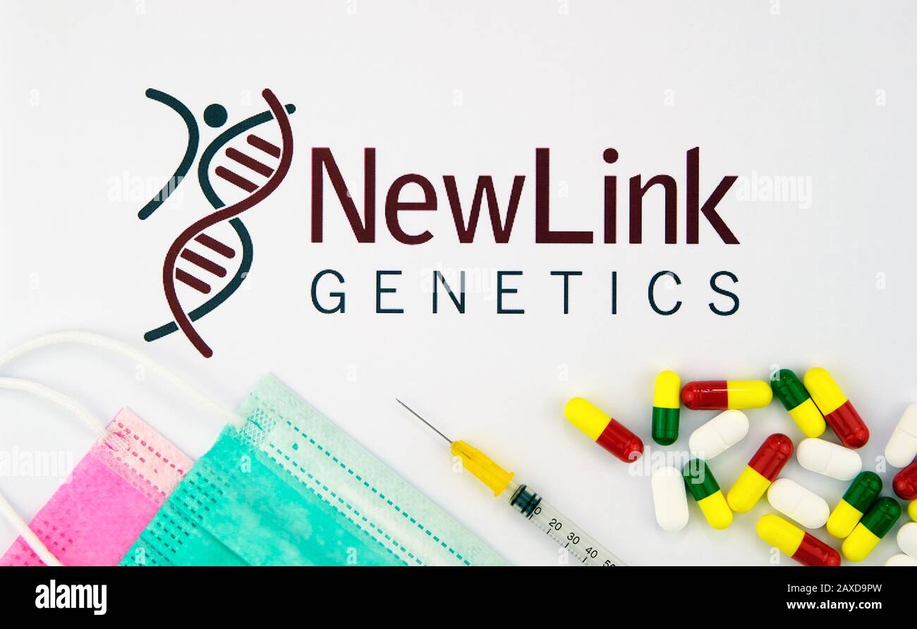 NewLink Genetics vaccine company logo seen on a brochure with the viral masks, vaccine syringe and pills. Concept photo. Stock Photo