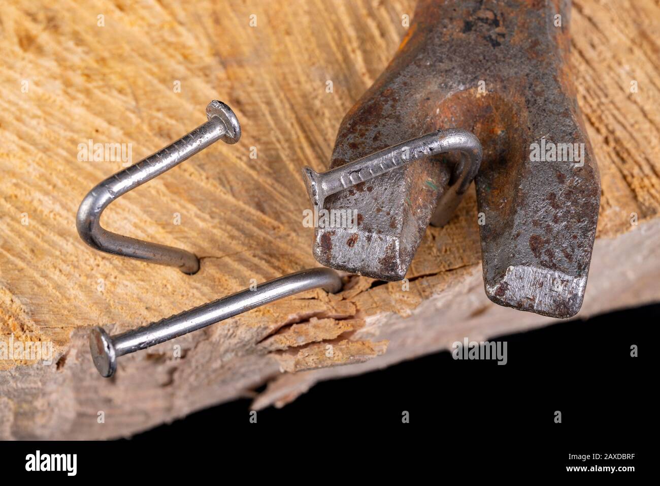 Extracting old nails from a piece of raw wood. Carpentry work in the