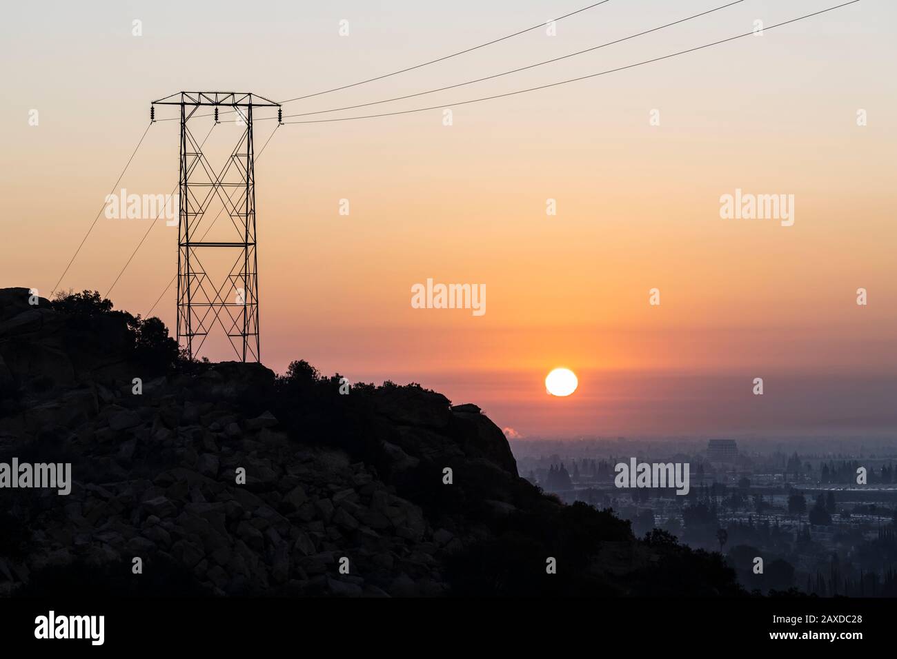 Electric power tower hilltop sunrise at Santa Susana Pass State Historic Park in Los Angeles California. Stock Photo