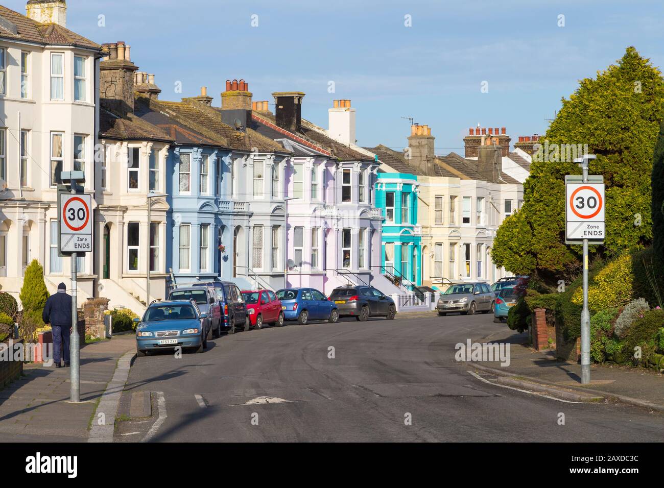 Row of colourful victorian terraced houses with 30 mph zone ends signs, hastings, uk Stock Photo