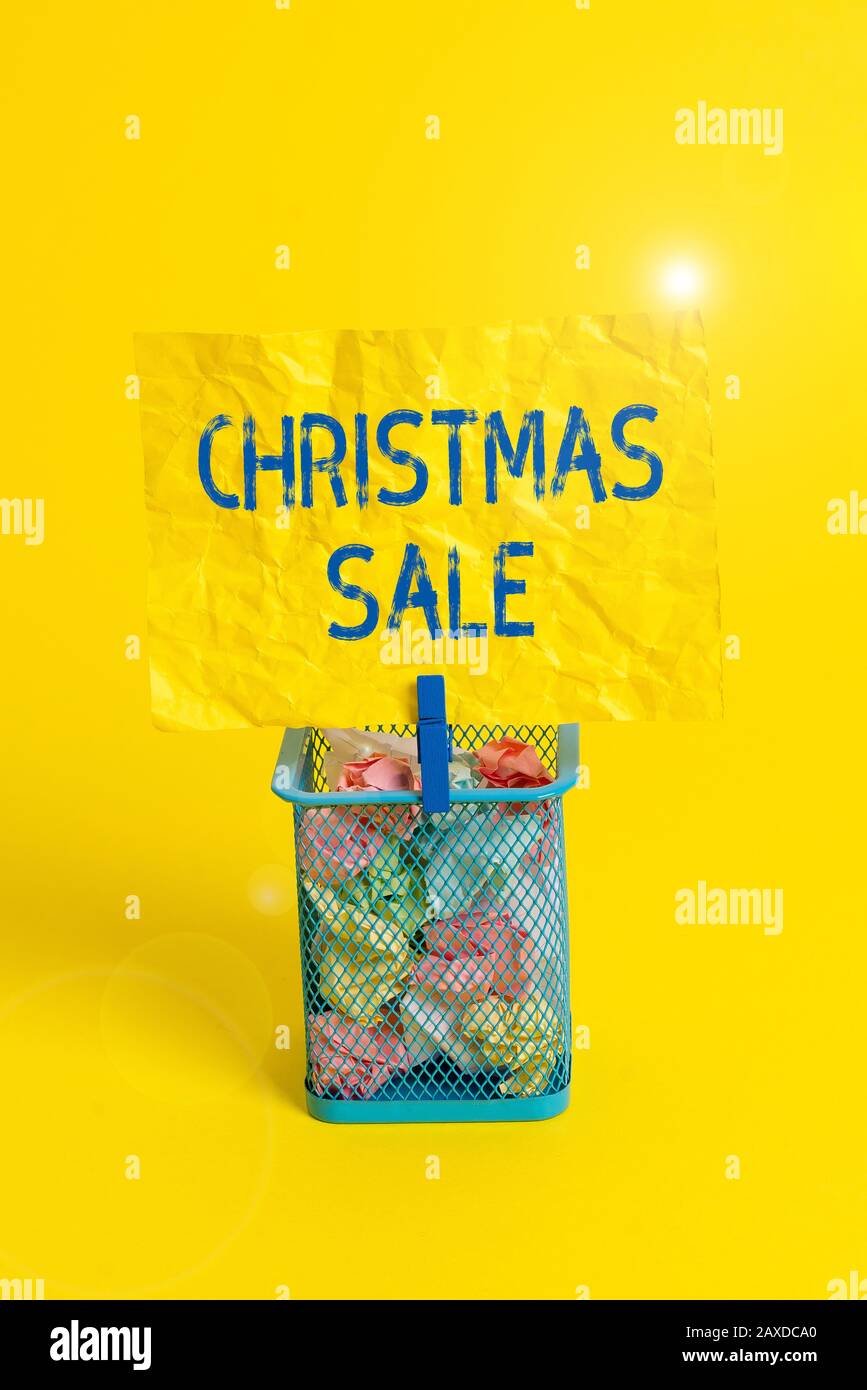 Text sign showing Christmas Sale. Business photo text period during which a retailer sells goods at reduced prices Trash bin crumpled paper clothespin Stock Photo
