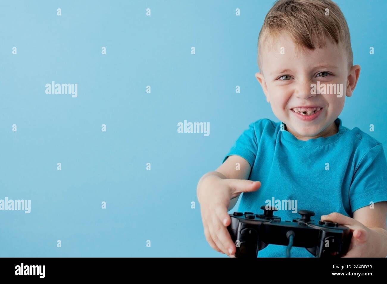 Little kid boy 2-3 years old wearing blue clothes hold in hand joystick ...