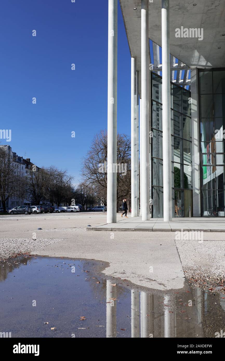 Munich, Germany - February 20, 2020: Pillars reflection of the Pinakothek der Moderne or the Museum of Modern Arts in Munich, Germany under a blue sky Stock Photo
