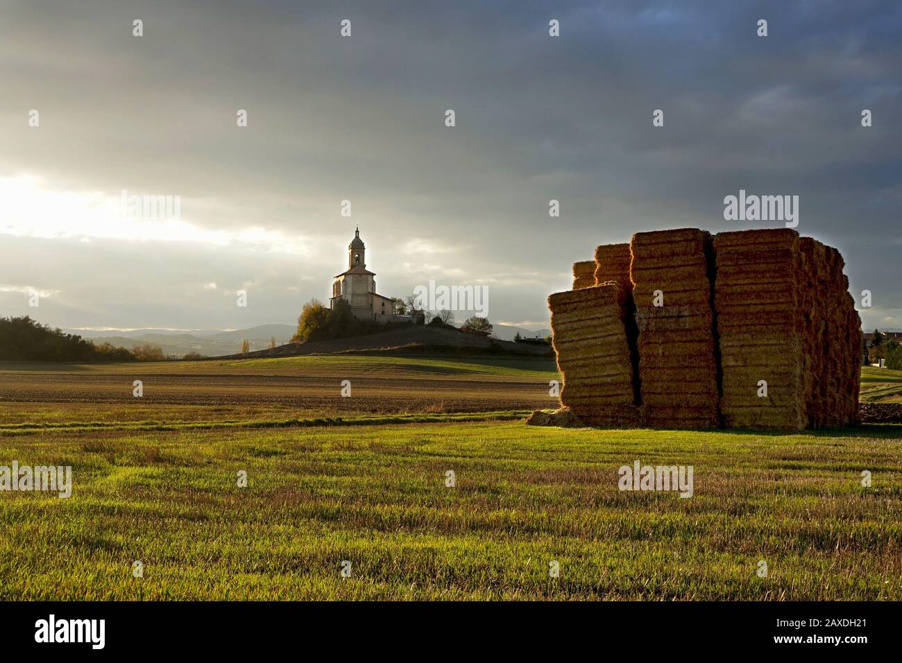 A freshly cut fiean old Church stood alone on a hill in the sunlight Stock Photo