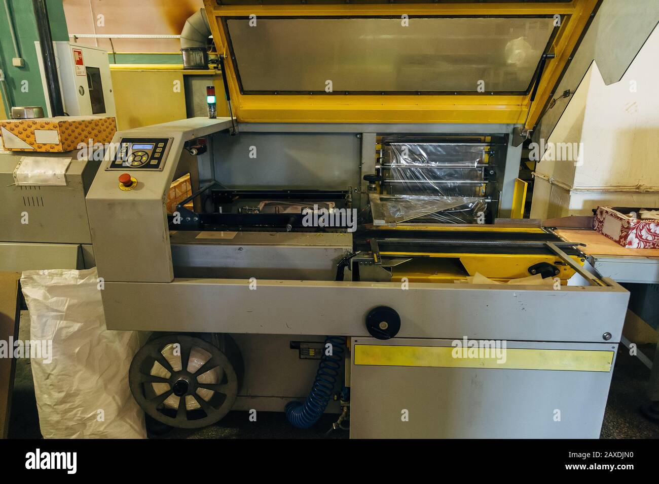 Food packing machine. Packing cookies into cardboard boxes and coating