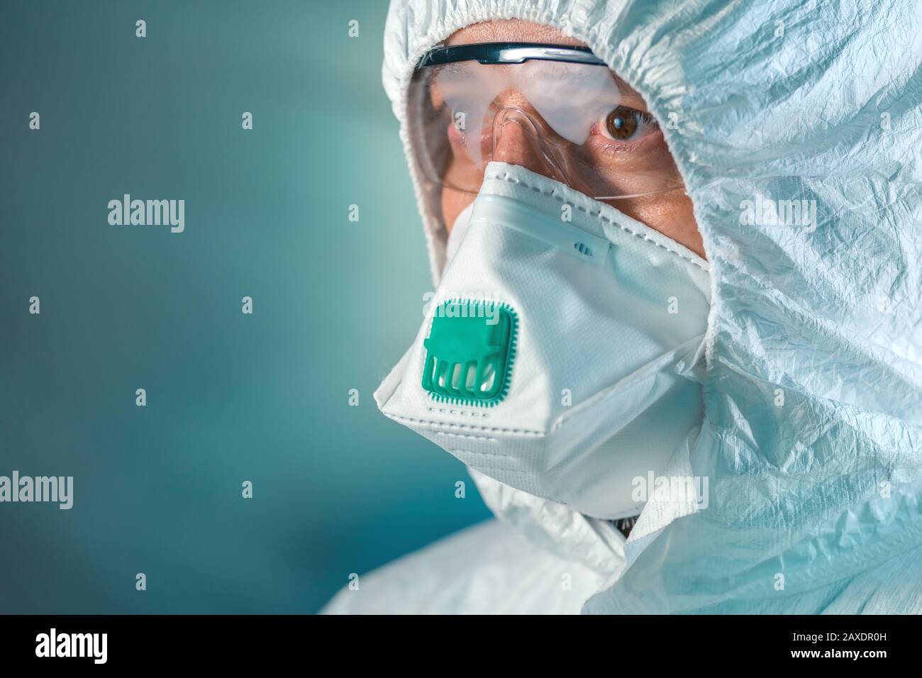Tired epidemiologist in wuhan-coronavirus quarantine, conceptual image of medical specialist wearing protective clothing and mask. Stock Photo