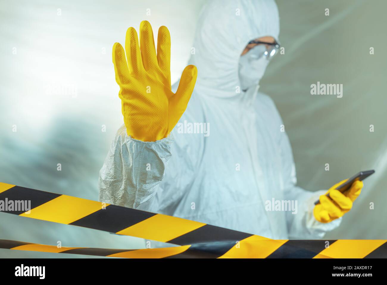 Epidemiologist using smartphone in hospital virus infection quarantine and gesturing stop hand sign, selective focus Stock Photo