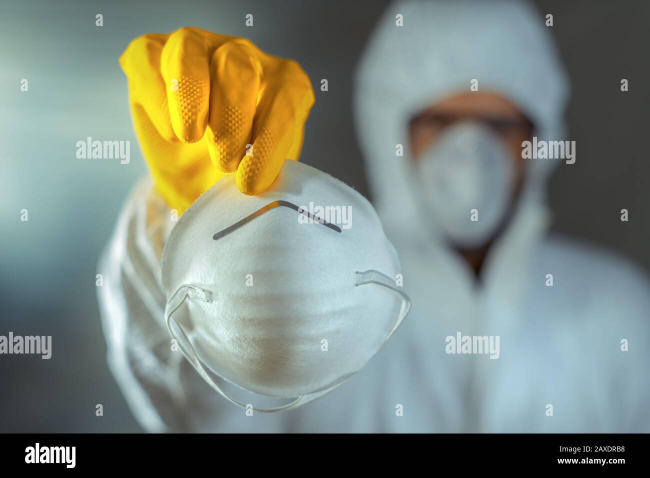 Medical worker giving single use protective respirator mask, close up with selective focus Stock Photo