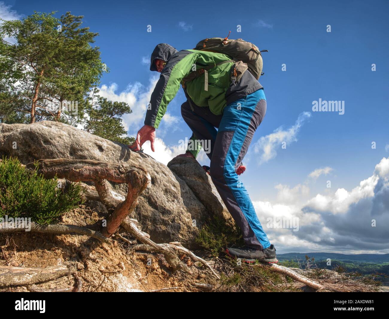 Man climbing steep mountain slope. Sunny windy day in rocks Stock Photo ...