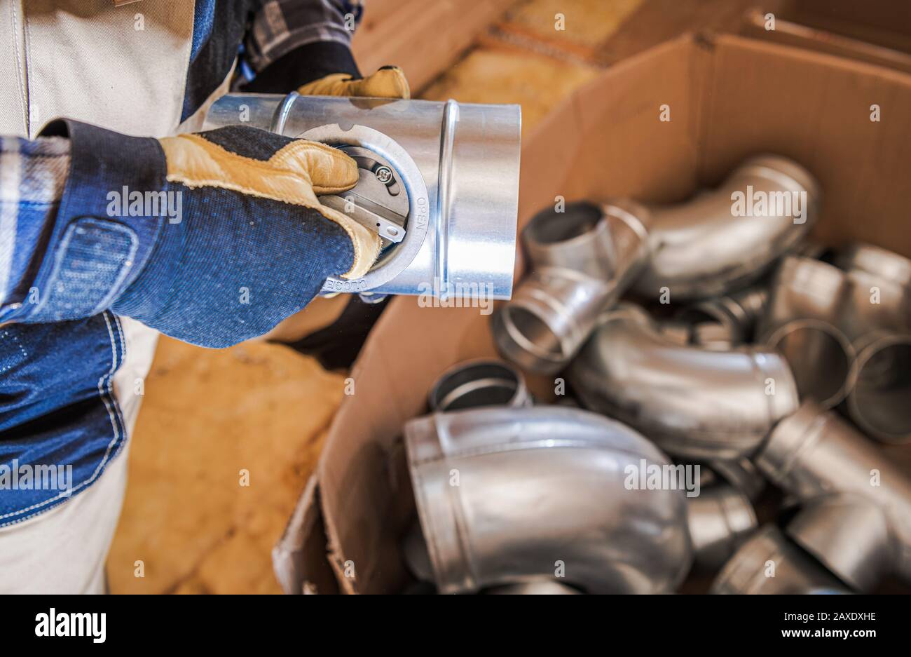 Air Vent Pipeline System Elements. Technician with Air Valve in His Hands. Ventilation Contractor. Stock Photo