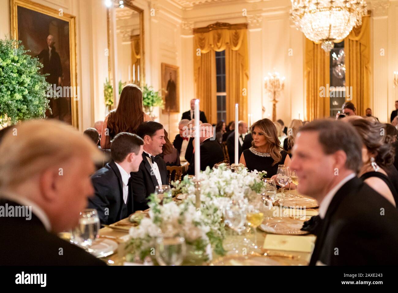 U.S President Donald Trump and First Lady Melania Trump chat with guests during the Governors Ball in the East Room of the White House February 9, 2020 in Washington, DC. Stock Photo