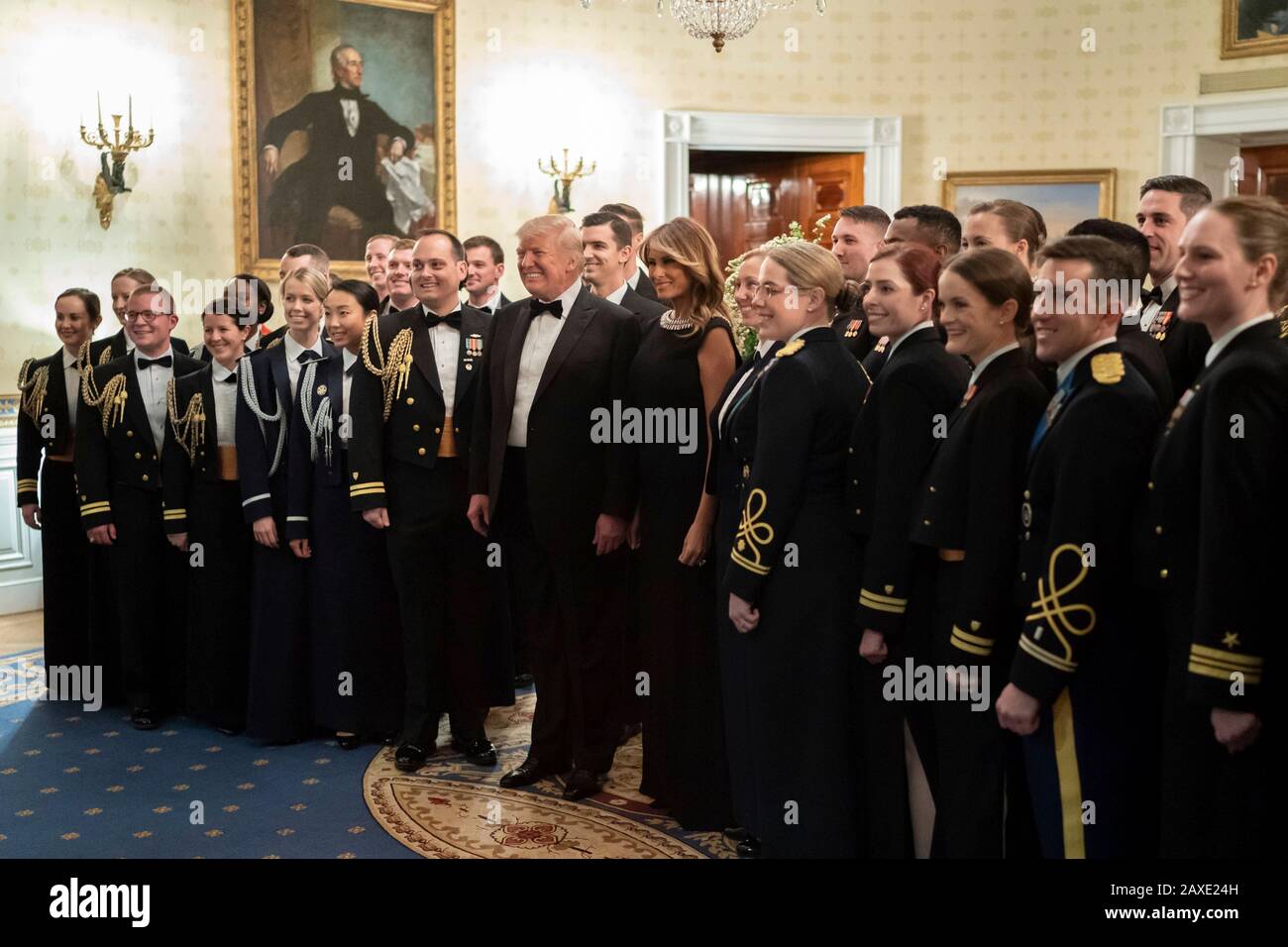 U.S President Donald Trump and First Lady Melania Trump address pose for a portrait with the White House Social Aides prior to the Governors Ball in the Blue Room of the White House February 9, 2020 in Washington, DC. Stock Photo