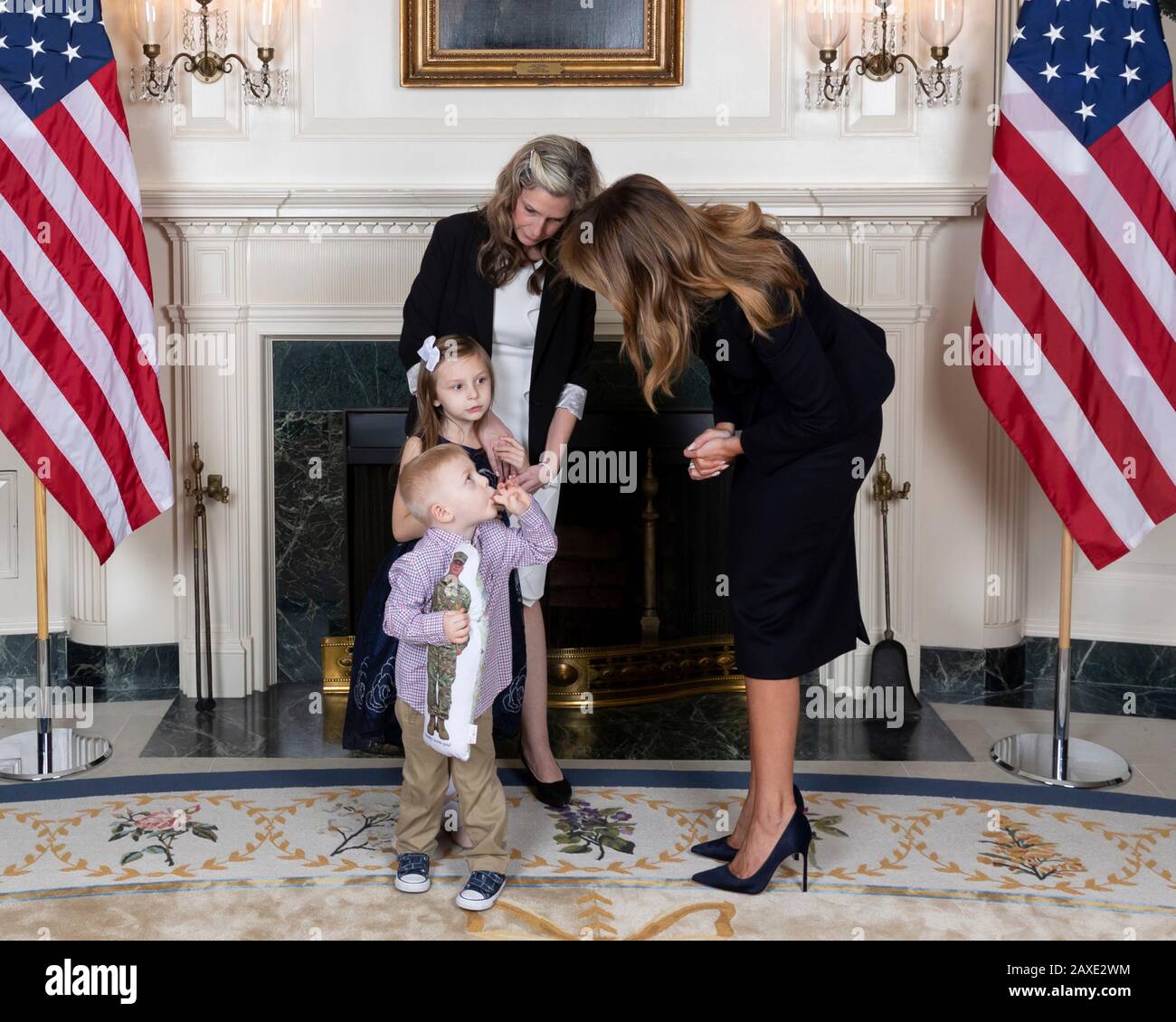 U.S First Lady Melania Trump greets Amy Williams and her children 6 year-old Elliana and 3 year-old Rowan during a reception for State of the Union gallery guests in the Diplomatic Reception Room of the White House February 4, 2020 in Washington, DC. Stock Photo