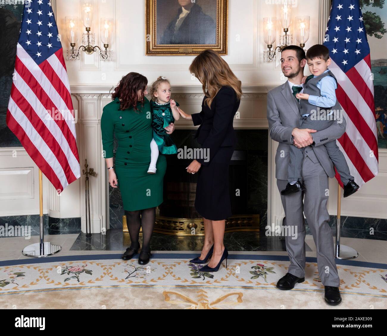 U.S First Lady Melania Trump poses with Robin Schneider, her daughter Ellie Schneider and her husband during a reception for State of the Union gallery guests in the Diplomatic Reception Room of the White House February 4, 2020 in Washington, DC. Stock Photo