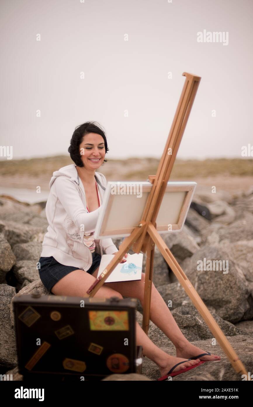 Artist painting at the beach Stock Photo - Alamy